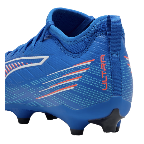 Side profile of a royal blue Puma Ultra soccer boot with orange "ULTRA" text, white and red graphic stripes, and a black-tipped studded sole.