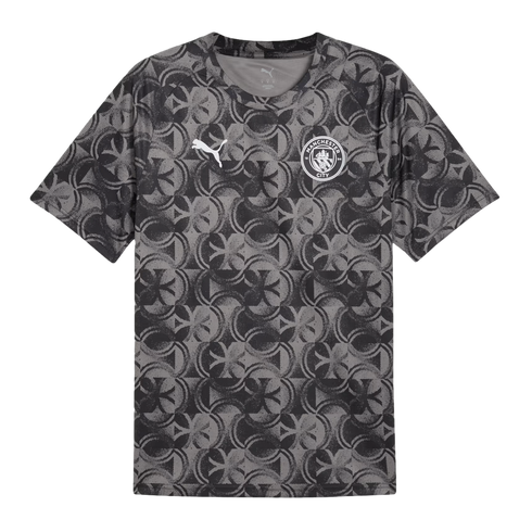 Grey short-sleeved t-shirt with a repeating black circular pattern, a white Puma logo on the right chest, and a Manchester City crest on the left.