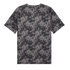 The back view of a dark grey and black T-shirt with a repeating, interlocking geometric floral and circular pattern across its entirety, presented on a solid black background.