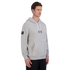 Man wearing a grey hoodie with white drawstrings and black sweatpants, standing against a plain black background.
