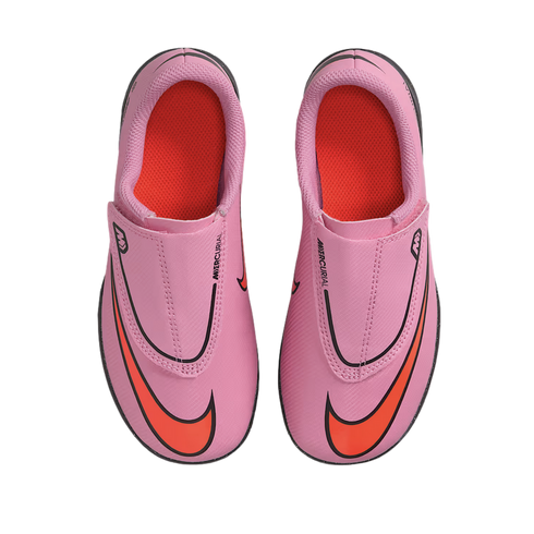 Top-down view of a pair of pink Nike Mercurial soccer cleats with bright orange accents on a black background.