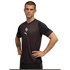 A man with short hair poses with hands on his hips, wearing a black and maroon patterned Puma athletic shirt with a white logo on the chest, against a solid black background.