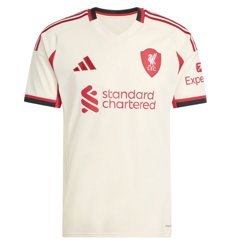 Cream Liverpool F.C. football jersey with red and black trim. Features the Adidas logo, team crest, and Standard Chartered sponsor logo on the front.