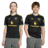 Two young people wearing matching black Manchester United jerseys with yellow "Snapdragon" logos, standing against a plain black background.