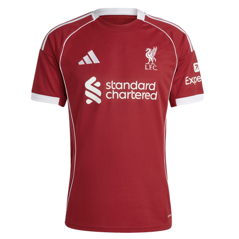 A red Liverpool FC football jersey by Adidas featuring white piping, the club's Liver Bird crest, and the Standard Chartered sponsor logo in white.