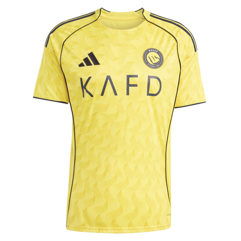 A yellow Al-Nassr FC soccer jersey by Adidas with a subtle tone-on-tone wavy pattern, black KAFD sponsor logo, and dark piping along the shoulders and sleeves.