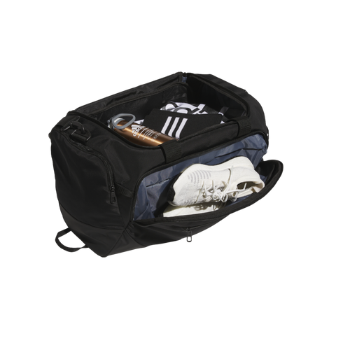 Open black Adidas duffel bag filled with gear, including a copper water bottle and white sneakers in a separate side compartment.