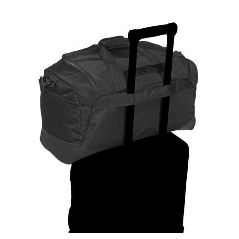 A black duffel bag with a trolley sleeve secured over the telescopic handle of a suitcase, against a black background.