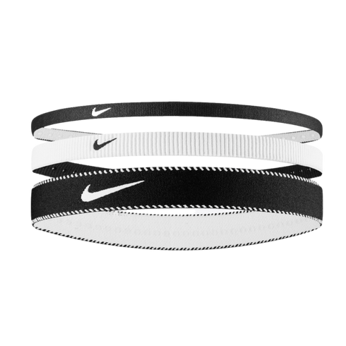Three Nike headbands stacked vertically: thin black, thin white, and thicker black with white stitching. Each features the swoosh logo. Set against a black background.