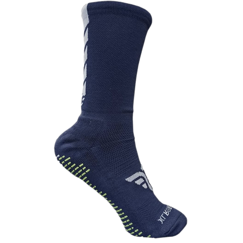 A navy blue crew-length athletic sock with white geometric accents and lime green non-slip grip pads on the sole, set against a black background.