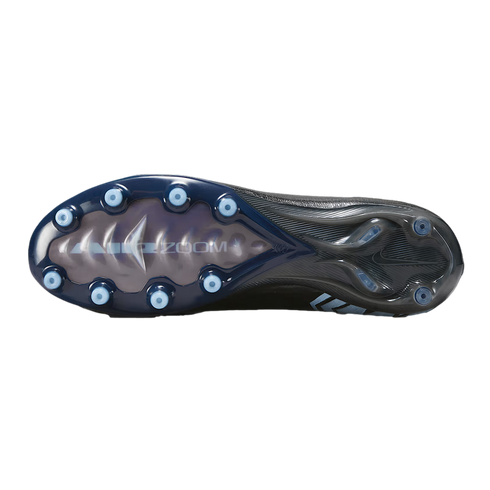 The bottom view of a Nike soccer cleat with a dark blue and black soleplate, light blue conical studs, and "AIR ZOOM" branding.