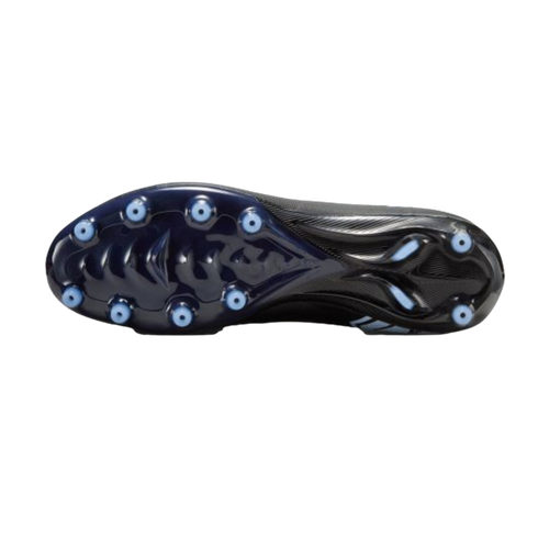 The underside of a dark navy soccer cleat with light blue circular studs, shown against a solid black background.