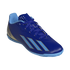 A royal blue Adidas indoor soccer shoe featuring three light blue diagonal stripes and "Messi" branding on the heel.