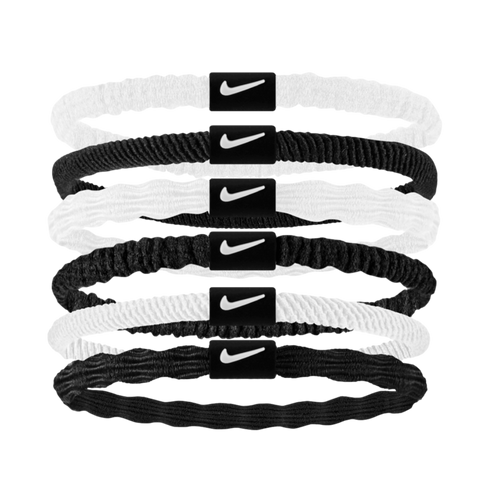 Six stacked Nike hair elastics in alternating white and black. Each band features a central black plastic tab with a white swoosh logo.