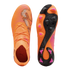 Top and bottom views of bright orange Puma soccer cleats featuring black textured stripes and pink-tipped studs on the sole.
