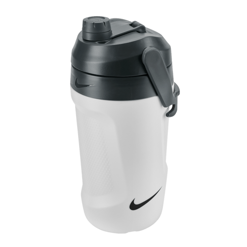 A white Nike water jug with a dark gray lid, side handle, and screw-top cap. It features a textured grip and black Nike swoosh logos.
