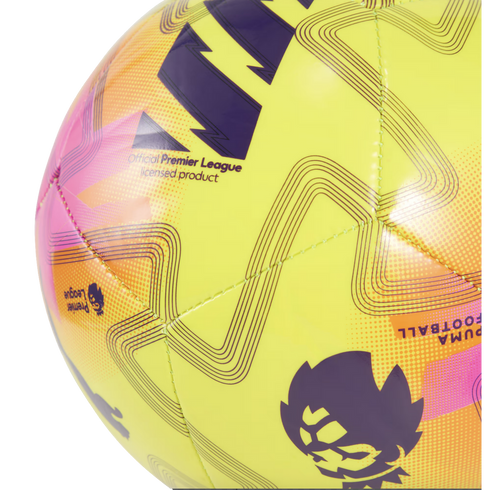 Close-up of a bright yellow PUMA Premier League soccer ball featuring purple and pink geometric patterns and the league's lion logo.