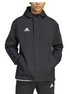 Man wearing a black hooded Adidas jacket with a white chest logo and matching black track pants.