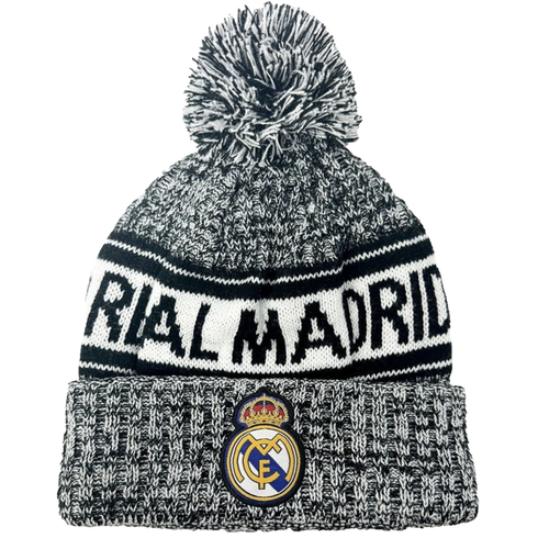 Real Madrid black and white knitted beanie with a pom-pom, featuring the team name across the middle and the club crest on the folded brim.