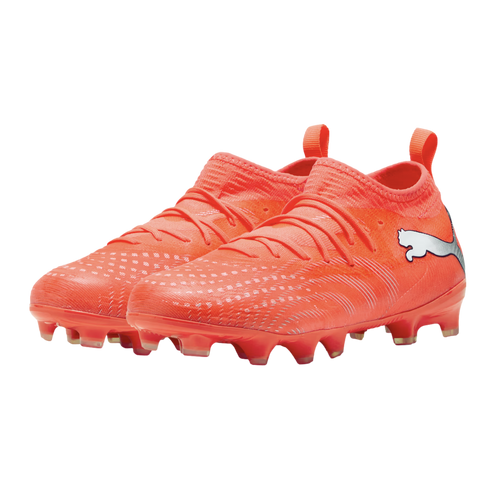 A pair of bright orange Puma soccer cleats featuring a silver logo, textured upper, and integrated sock-like collar, shown against a solid black background.