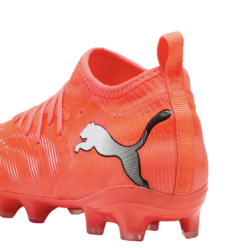 Close-up of a bright orange Puma soccer cleat with a sock-like collar and white logo against a black background.
