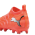 Close-up of a bright orange Puma soccer cleat with a sock-like collar and white logo against a black background.