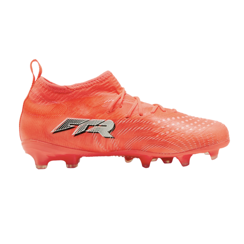 Side view of a bright orange mid-cut soccer cleat with a black and white "GTR" logo on the side and a textured upper, set against a solid black background.
