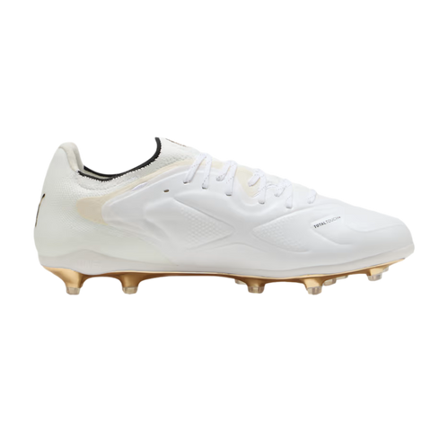 Side profile of a white PUMA soccer cleat with a metallic gold soleplate and studs, set against a solid black background.