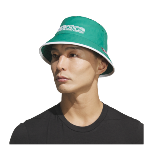 Man wearing a green bucket hat with white "MEXICO" text and a black t-shirt against a black background.