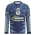 Navy blue Adidas Club América long-sleeve jersey featuring pale yellow logos and large light blue pre-Hispanic eagle warrior patterns on the shoulders and sleeves.