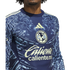 Close-up of a navy blue Club América soccer jersey with a light blue eagle pattern, yellow Adidas logo, and "Caliente" sponsor logo.