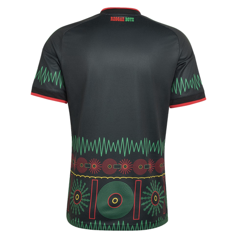 Back view of a black Reggae Boyz soccer jersey with green zigzag sleeve patterns and a vibrant red, yellow, and green graphic design along the bottom.