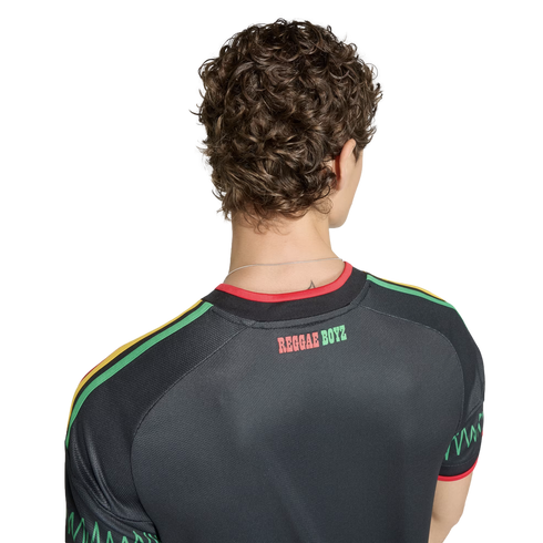 Back view of a person wearing a black Jamaica soccer jersey with "REGGAE BOYZ" text and red, yellow, and green accents on the shoulders.