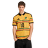Man in a yellow Adidas Jamaica jersey with number 10 and black, red, and green patterned stripes, against a black background.