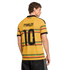 Rear view of a man in a yellow Jamaica "Marley 10" jersey with green, red, and black patterned stripes against a black background.