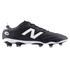 A side view of a black New Balance 442 soccer boot featuring a large white logo, a white midsole, and black studs with clear tips against a solid black background.