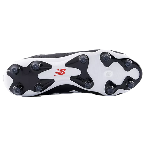 The white and black sole of a New Balance soccer cleat, featuring a red logo and conical studs for traction on grass.