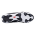 The white and black sole of a New Balance soccer cleat, featuring a red logo and conical studs for traction on grass.