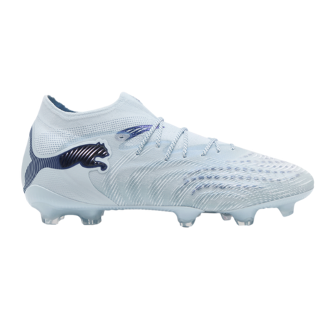 Side view of a light blue Puma soccer cleat with iridescent logos and clear studs against a solid black background.