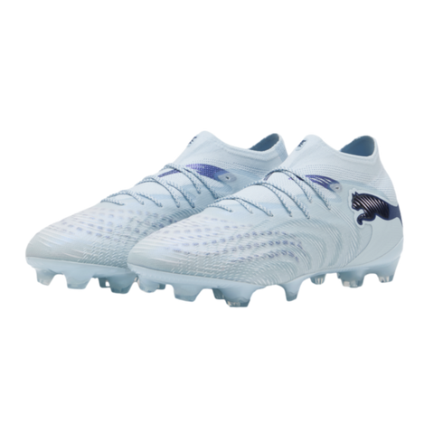 Light blue and white Puma soccer cleats with textured uppers and dark blue branding, isolated on a black background.