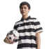 A man in a black and white striped Juventus polo shirt holding a soccer ball against a black background.