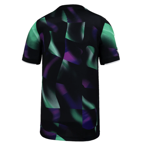 Back view of a black short-sleeved jersey featuring a vibrant green and purple abstract wave pattern. The sleeves have thin white cuffs.