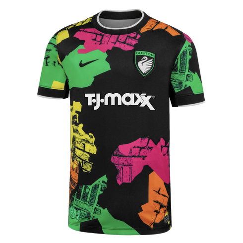 Black Nike soccer jersey with a 'BOSTON' swan crest, T.J. Maxx sponsor, and a bold, colorful abstract pattern of textured shapes in green, pink, and orange.