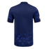 Back view of a navy blue polo-style jersey with light blue thistle patterns on the sleeves and bottom hem, and pink jagged trim on the sleeve cuffs.