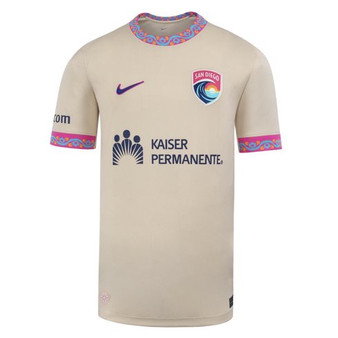 A tan Nike soccer jersey for San Diego Wave FC with colorful patterned collar and sleeve cuffs, featuring the team's crest and a Kaiser Permanente sponsor logo.