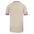 Back of a beige jersey with pink and turquoise patterned trim on the collar and cuffs, featuring a small blue logo on the right sleeve.