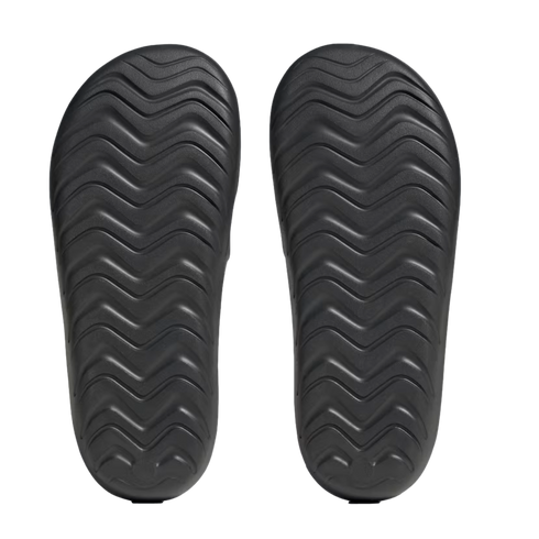 Top-down view of two black sandal soles with a wavy zigzag tread pattern, set against a plain white background.