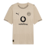 Beige Puma soccer jersey with a black BVB crest and Vodafone logo. Subtle geometric patterns cover the shirt, which has striped details on the collar and cuffs.