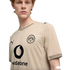 A young man with red hair wearing a tan BVB 09 soccer jersey by Puma with a black Vodafone logo, set against a plain black background.
