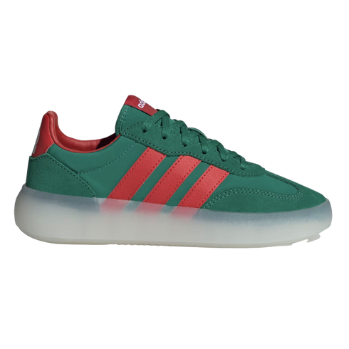 A low-top Adidas sneaker with a dark green upper, three red stripes, and a thick, translucent white platform sole against a black background.